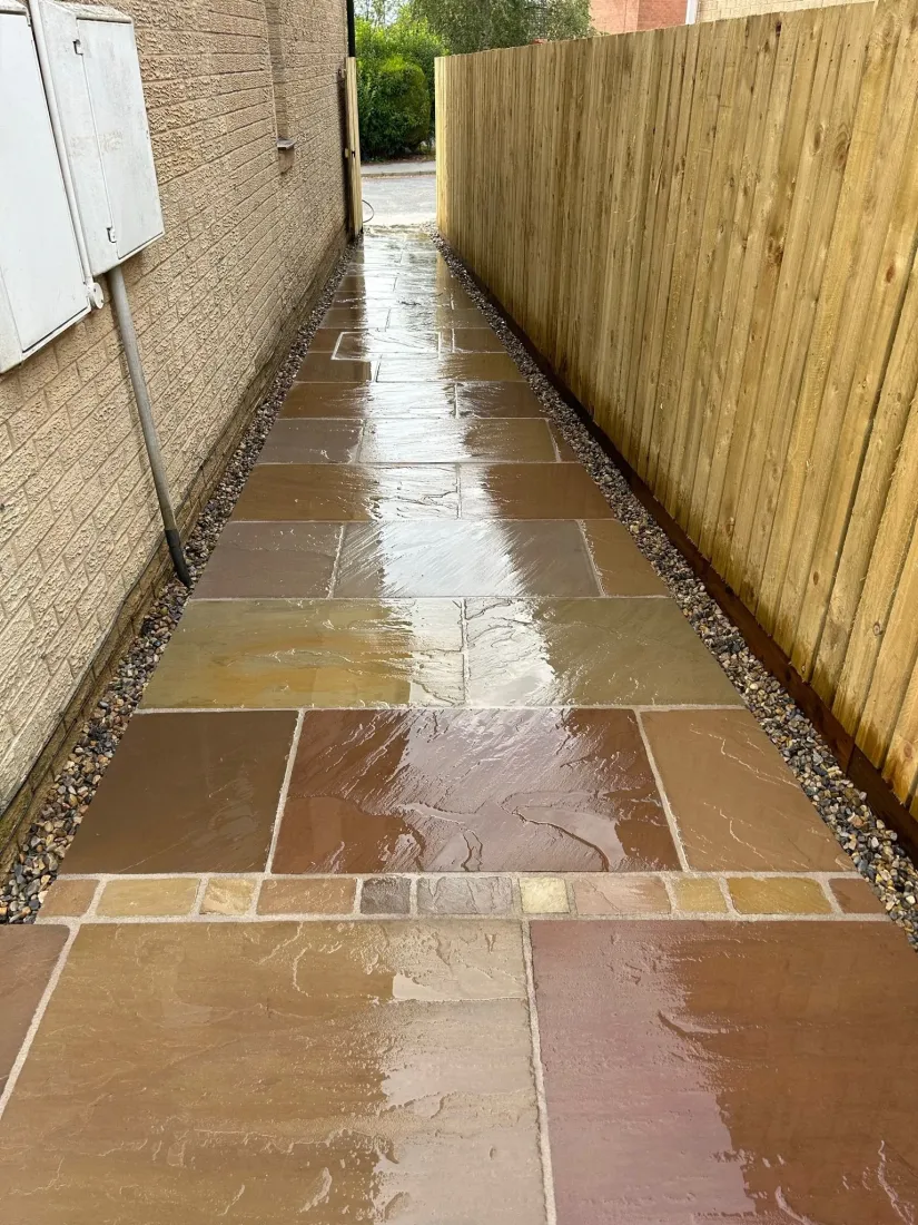 Paved path alongside a new timber fence