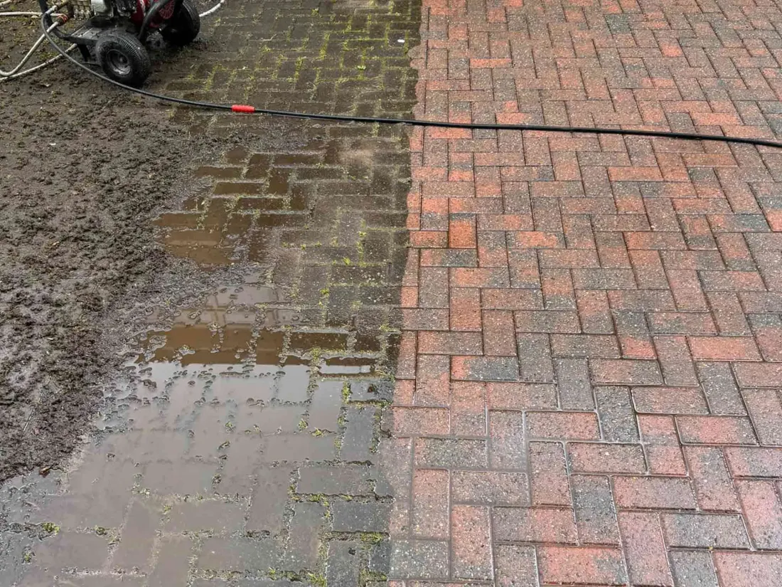 Before and after pressure washing on a block-paved driveway