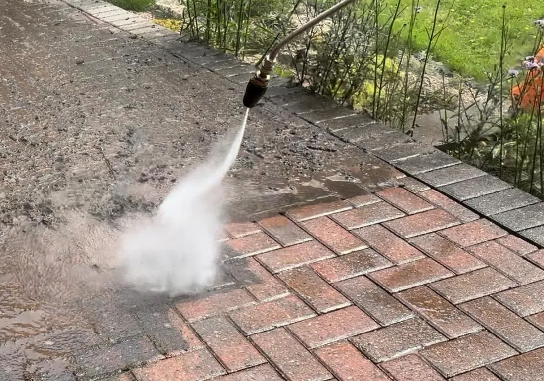 Pressure washing a paved area